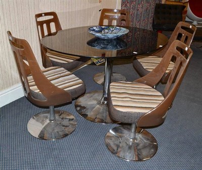 Lot 1306 - A 1960's/70's Dining Room Suite, comprising a Table, with oval smokey glass top on a chrome...