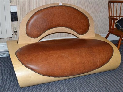 Lot 1312 - Douglas Arnold (b.1976): A Bent Birch Ply and Leather Sofa, with nailed brown leather seat and...