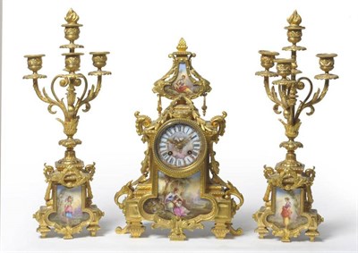 Lot 1328 - A Porcelain Mounted Striking Mantel Clock with Garniture, circa 1890, with mask and swag leaf...