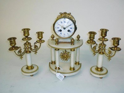 Lot 1331 - A Gilt Metal and White Marble Striking Mantel Clock with Garniture, circa 1890, the portico...