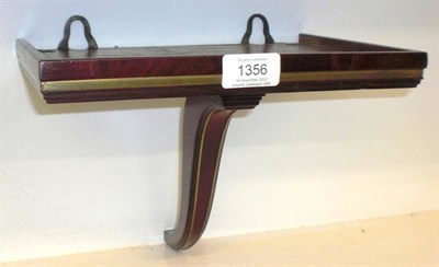 Lot 1356 - A Regency Mahogany and Brass Clock Wall Bracket, nicely figured veneer with brass bound border,...