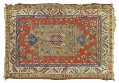 Lot 1379 - Bergama Rug West Anatolia The rust field of stylised flowerheads around a mint green lozenge...