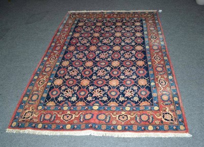 Lot 1382 - Veramin Carpet Central Persia The indigo lattice field of flowerheads enclosed by rust borders...