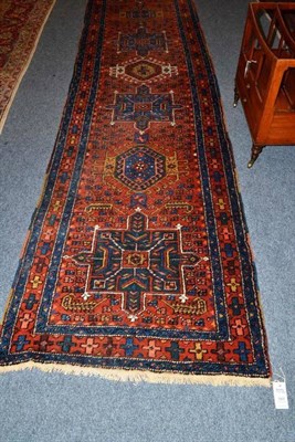 Lot 1400 - Narrow Heriz Runner Persian Azerbaijan The rust field with a single column of hooked and...