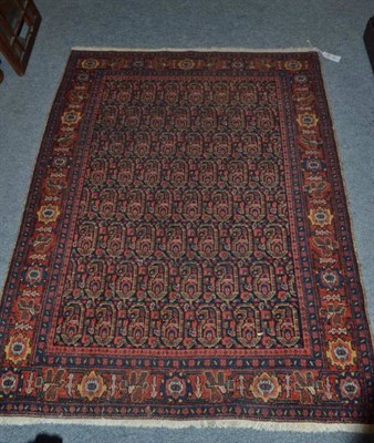 Lot 1406 - Senneh Rug Persian Kurdistan The deep indigo field with columns of boteh enclosed by madder borders