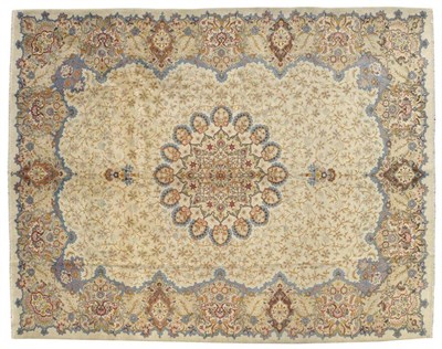 Lot 1422 - Kashan Carpet Central Persia The ivory field with a lattice of leafy vines around a roundel...