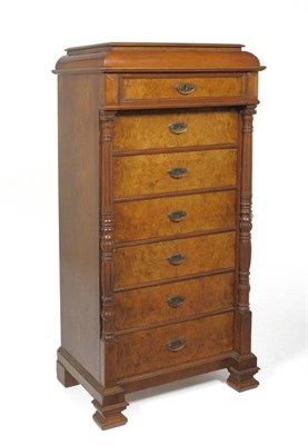 Lot 1450 - A French Walnut Semanier, 2nd half 19th century, the staged top above a frieze drawer with six...