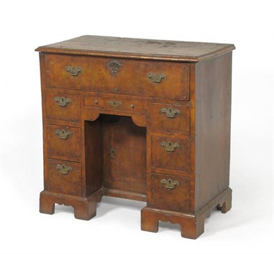 Lot 1461 - An Early Georgian Style Walnut, Feather Banded and Crossbanded Kneehole Desk, with secretaire...