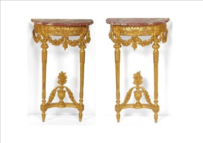 Lot 1464 - A Pair of Gilt and Gesso Demi-Lune Console Tables, with rouge royale marble tops above a...