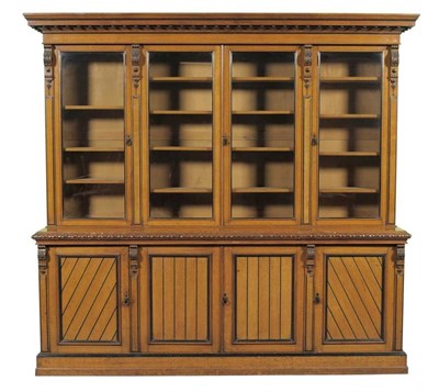 Lot 1477 - A Late Victorian Oak and Ebony Banded Bookcase, circa 1880, with a bold ball surmounted cornice...