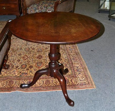 Lot 1487 - A George III Mahogany Tripod Table, late 18th century, with flip top, turned vasiform support,...