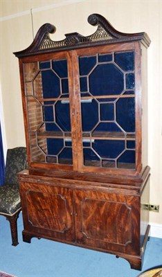 Lot 1497 - A George III Mahogany Bookcase, late 18th century, with scrolled and gothic style fretwork pediment