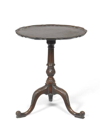 Lot 1520 - A George II Style Mahogany Tripod Table, the circular pie crust edge and moulded top above a fluted