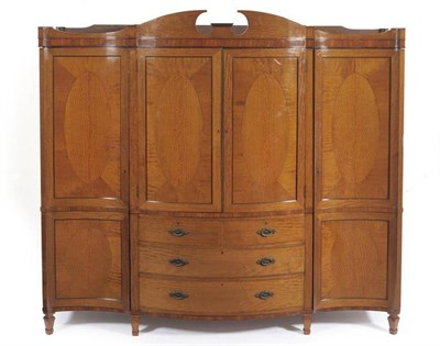 Lot 1526 - A George III Style Satinwood and Tulipwood Banded Wardrobe, late 19th century, of serpentine shaped