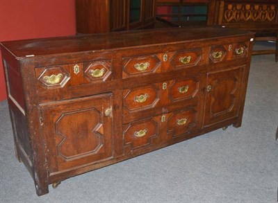 Lot 1555 - An Early 18th Century Joined Oak Sideboard Dresser, with geometric moulded drawers flanked by...