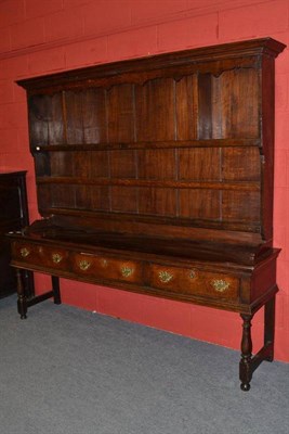 Lot 1556 - An Oak Dresser with Rack, 18th century, the bold cornice above a shaped frieze and three...