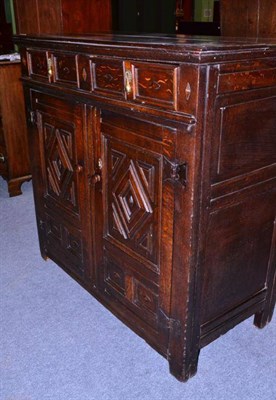 Lot 1562 - An Oak Cupboard, 17th century in part, with two frieze drawers above two geometric moulded cupboard