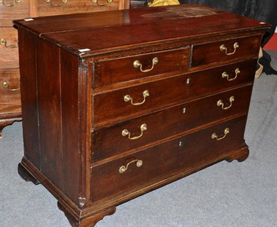 Lot 1563 - A George III Oak Straight Front Chest of Drawers, late 18th century, with two short over three long