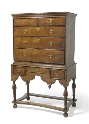 Lot 1566 - An Early 18th Century Oak Chest on Stand, with two short over three long graduated drawers, the...