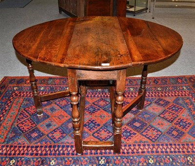 Lot 1580 - An Oak Six-Seater Gateleg Table, early 18th century in part, with two rounded drop leaves above...