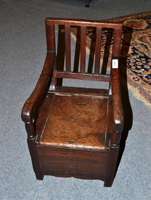 Lot 1582 - An Oak and Elm Child's Armchair, with triple reeded splat support, downswept arms above a...