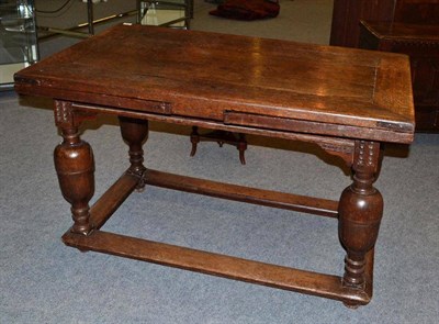 Lot 1583 - A Dutch Oak Extending Dining Table, of rectangular form with cleated ends, above a plain frieze...