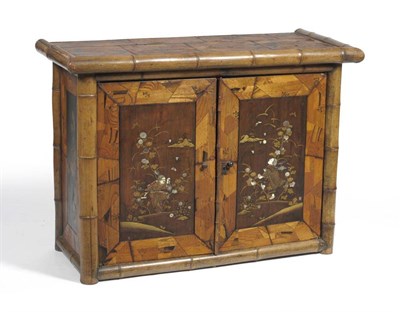 Lot 1632 - A 19th Century Japanese Elm, Parquetry and Bamboo Side Cabinet, with two hinged doors richly inlaid