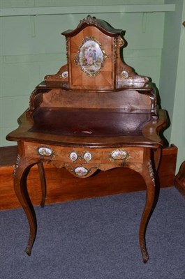 Lot 1641 - A Victorian Figured Walnut Louis XV Style Table à Écrire, late 19th century, with porcelain...