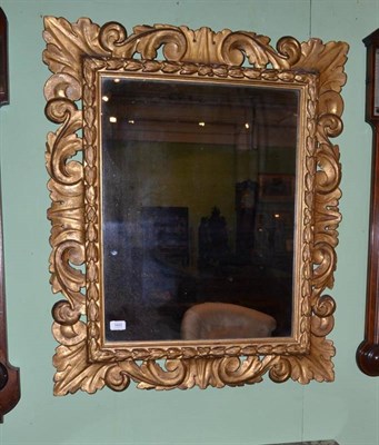 Lot 1665 - An Italian Carved Giltwood Picture Frame, richly decorated with acanthus S scrolls, containing...