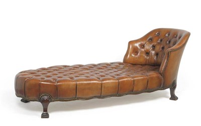 Lot 1675 - An Early 20th Century Brown Leather Day Bed, with close nailed padded back support and...