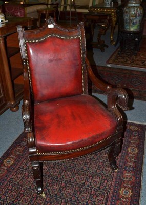 Lot 1676 - A Carved Mahogany Open Armchair, late 19th century, upholstered in close-nailed red leather...