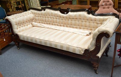 Lot 1682 - A Victorian Carved Rosewood Scroll End Settee, mid 19th century, upholstered in modern cream...