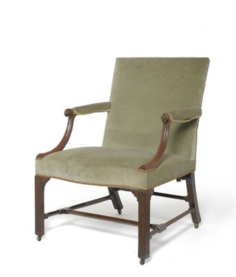 Lot 1698 - A George III Mahogany Library Armchair, late 18th century, recovered in green velvet fabric, carved