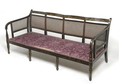 Lot 1700 - A Regency Black Japanned Four-Seater Settee, early 19th century, with single canework back...