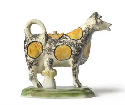 Lot 47 - A Pratt-Type Pottery Cow Creamer and Cover, circa 1800, the standing beast with ochre spots and...