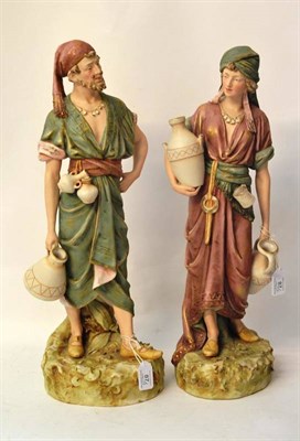 Lot 87 - A Pair of Royal Dux Porcelain Figures of Water Carriers, early 20th century, the standing...