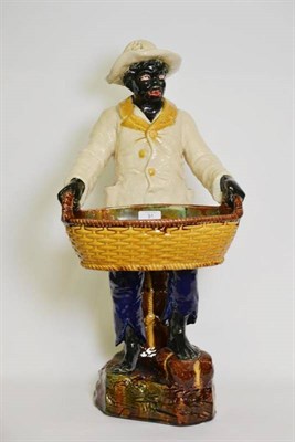 Lot 91 - A Majolica Style Figural Jardinière, late 19th/early 20th century, as a standing negro wearing...