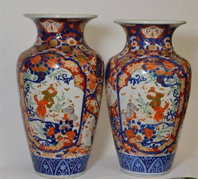 Lot 100 - A Near Pair of Imari Porcelain Baluster Vases, Meiji period (1868-1912), with everted rims,...