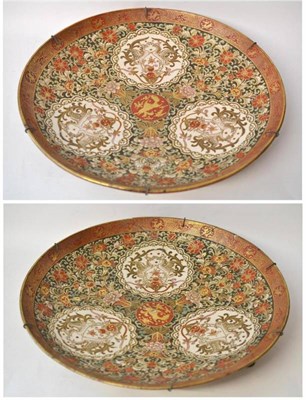 Lot 104 - A Pair of Kutani Earthenware Chargers, late 19th century, painted with a central mon within...