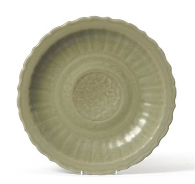 Lot 108 - A Longquan Celadon Dish, Ming Dynasty, carved with a lotus blossom in a circular panel within a...