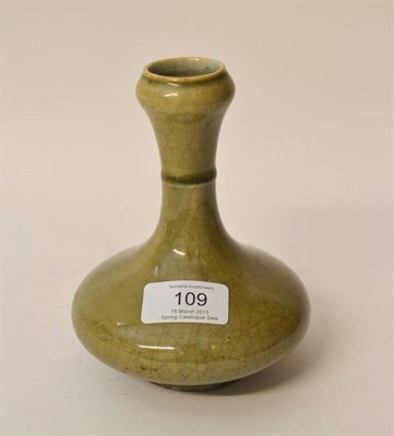 Lot 109 - A Chinese Celadon Glazed Bottle Vase, with garlic neck and collar to the stem over a swelling base
