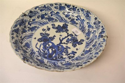 Lot 122 - A Chinese Porcelain Dish, Kangxi, painted in underglaze blue with peony and rockwork in a...