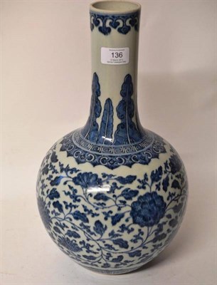 Lot 136 - A Chinese Porcelain Blue and White Bottle Vase, the rim with repeat ruyi head motifs over tall leaf