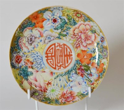 Lot 162 - A Chinese Famille Rose Saucer, bears Qianlong reign mark, decorated with central mon and millefiori