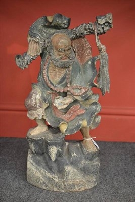 Lot 177 - A Chinese Polychrome Figure, in Ming style, the bearded man in flowing robes holding a branch...