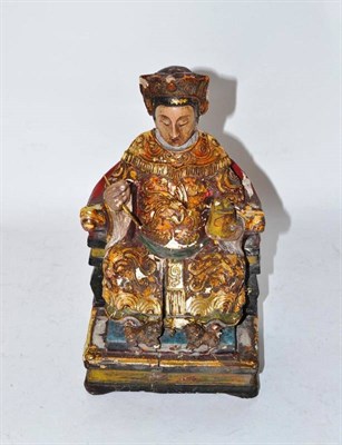 Lot 178 - A Chinese Polychrome Wood Figure of a Seated Dignitary, in Ming style, in formal dress holding...