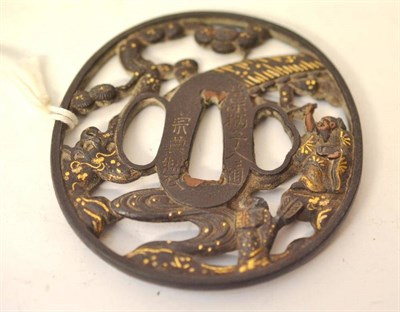 Lot 200 - A Japanese Gold Inlaid Iron Tsuba, cast and pierced with a warrior and with foliage, 8cm