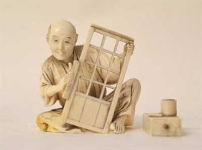 Lot 208 - A Japanese Ivory Okimono, Meiji period (1868-1912), as a carpenter sitting planing a window...