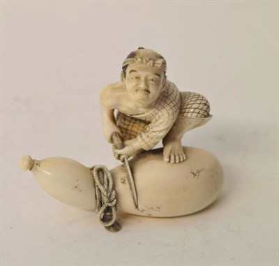 Lot 209 - A Japanese Ivory Okimono, Meiji period (1868-1912), as a man in loose robes standing, one foot on a