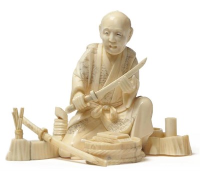 Lot 211 - A Japanese Ivory Okimono, Meiji period (1868-1912), as a swordsmith, the kneeling figure in...